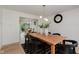 Cozy dining room with views to the outdoor space, stylish light fixture, and wood table at 12118 Castle Row Overlook, Carmel, IN 46033