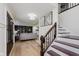 Inviting foyer featuring wood floors, staircase, and easy access to the living area at 12118 Castle Row Overlook, Carmel, IN 46033