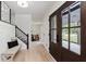 Bright entryway with stylish bench seating, wood floors, and staircase access at 12118 Castle Row Overlook, Carmel, IN 46033