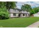 Charming home with stone accents, covered entryway, lush lawn, and mature trees at 12118 Castle Row Overlook, Carmel, IN 46033