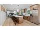 Spacious kitchen features a large island with seating, stainless steel appliances, and a view into the living area at 12118 Castle Row Overlook, Carmel, IN 46033