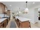 Bright, open kitchen features stainless steel appliances and hardwood floors at 12118 Castle Row Overlook, Carmel, IN 46033