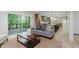 Open concept living room with hardwood floors and sliding glass doors to a back deck at 12118 Castle Row Overlook, Carmel, IN 46033