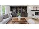 Comfortable living room featuring built-in shelving, stone fireplace, and a cozy seating area at 12118 Castle Row Overlook, Carmel, IN 46033