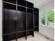 Functional mudroom features a large storage area, a window to the outside, and light colored flooring at 12118 Castle Row Overlook, Carmel, IN 46033