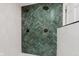 Unique shower features dual shower heads and stunning green tiling at 12118 Castle Row Overlook, Carmel, IN 46033