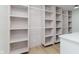 Spacious walk-in closet featuring custom shelving and bright lighting at 12118 Castle Row Overlook, Carmel, IN 46033