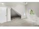 Bright attic bedroom featuring sloped ceilings and neutral colored carpet at 1217 Newman St, Indianapolis, IN 46201