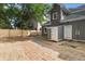 Fenced backyard featuring a gray home exterior, storage shed, and a fresh gravel path with ample open space at 1217 Newman St, Indianapolis, IN 46201
