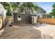 Well-maintained backyard showing the gray home, a small shed, new gravel, and wooden fence under a leafy tree at 1217 Newman St, Indianapolis, IN 46201