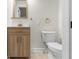 Well-lit powder room with modern fixtures, new cabinets, and neutral tones at 1217 Newman St, Indianapolis, IN 46201