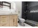 Updated bathroom with sleek black tile shower, modern vanity, and ample lighting at 1217 Newman St, Indianapolis, IN 46201