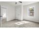 Inviting bedroom with ceiling fan, neutral carpet, and bright windows at 1217 Newman St, Indianapolis, IN 46201
