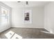 Sunlit bedroom with neutral carpet, white trim, and large windows at 1217 Newman St, Indianapolis, IN 46201
