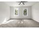 Well-lit bedroom featuring neutral carpet and two bright windows at 1217 Newman St, Indianapolis, IN 46201