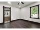 Bright bedroom with wood floors, ceiling fan and a view into the attached bathroom at 1217 Newman St, Indianapolis, IN 46201