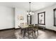 Dining room with a rustic table, modern chandelier and dark wood floors at 1217 Newman St, Indianapolis, IN 46201