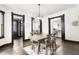 Bright dining room with wood floors, stylish light fixture, and easy access to the kitchen and living room at 1217 Newman St, Indianapolis, IN 46201