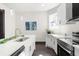 Modern kitchen features white cabinets, stainless steel appliances, and quartz countertops at 1217 Newman St, Indianapolis, IN 46201