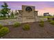 Lone Pine Farms community entrance with stone accents and lush landscaping against a serene sunset at 1326 Foxtail Ln, Greenwood, IN 46143