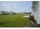 Backyard with manicured lawn, landscaping, and an adjacent walking path at 13448 Mosaic St, Fishers, IN 46037