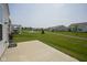 Scenic backyard view overlooking a well-manicured lawn and a tranquil pond with a fountain at 13448 Mosaic St, Fishers, IN 46037