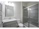 Bathroom with a walk-in shower, single sink, and updated tiling at 13448 Mosaic St, Fishers, IN 46037