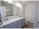 Bathroom with double sinks, stone countertop, framed mirror, and walk-in shower with glass doors at 13448 Mosaic St, Fishers, IN 46037