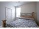 Bedroom with a sliding-door closet, a bed frame, and a large window with blinds at 13448 Mosaic St, Fishers, IN 46037