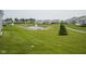 Scenic view of a community pond with fountains and well-manicured green space at 13448 Mosaic St, Fishers, IN 46037