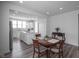 Eat-in kitchen with wood table and views of the island, stainless appliances, and white cabinets at 13448 Mosaic St, Fishers, IN 46037
