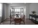 The dining room features a view of the well-appointed kitchen with stainless steel appliances and white cabinetry at 13448 Mosaic St, Fishers, IN 46037