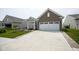 Charming brick home with a two-car garage and a well-paved driveway, surrounded by green landscaping at 13448 Mosaic St, Fishers, IN 46037