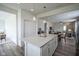 Kitchen island with eat-in seating, pendant lights, stainless appliances, and open-concept design at 13448 Mosaic St, Fishers, IN 46037