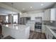 Kitchen with stainless steel appliances, white cabinets and large island, open to dining area and living room at 13448 Mosaic St, Fishers, IN 46037