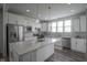 Bright kitchen featuring white cabinets, stainless steel appliances, and a center island at 13448 Mosaic St, Fishers, IN 46037