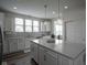 This kitchen has quartz counters, stainless appliances, pendant lighting and ample cabinet space at 13448 Mosaic St, Fishers, IN 46037