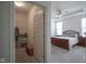View into bedroom, showing walk-in closet, carpet, a ceiling fan, and a wooden sleigh bed at 13448 Mosaic St, Fishers, IN 46037