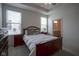 Main bedroom featuring tray ceilings, ceiling fan, and a view into the ensuite bathroom at 13448 Mosaic St, Fishers, IN 46037