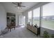 Bright sunroom with large windows, neutral carpet, and an exterior door at 13448 Mosaic St, Fishers, IN 46037