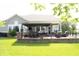 Backyard patio with pergola, outdoor seating, dining area, and well-maintained lawn at 13820 Woodside Hollow Dr, Carmel, IN 46032