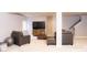 Finished basement space with neutral walls, carpeted floors, and a comfortable seating area for relaxation at 13820 Woodside Hollow Dr, Carmel, IN 46032