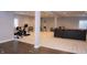 Spacious basement featuring gray sofa and weight equipment at 13820 Woodside Hollow Dr, Carmel, IN 46032