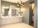 Luxurious bathroom with a double vanity, elegant mirrors, and a walk-in closet for optimal storage at 13820 Woodside Hollow Dr, Carmel, IN 46032