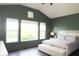 Bright bedroom with vaulted ceiling, large windows, a cozy bed, and neutral decor for relaxation at 13820 Woodside Hollow Dr, Carmel, IN 46032