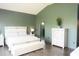 Serene bedroom with a vaulted ceiling, a comfortable bed, and an ensuite bathroom at 13820 Woodside Hollow Dr, Carmel, IN 46032