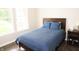 Bright bedroom with a comfortable bed, wood floors, and natural light from large windows at 13820 Woodside Hollow Dr, Carmel, IN 46032