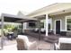 Covered patio with modern seating, dining set, and an outdoor lounge area for entertaining at 13820 Woodside Hollow Dr, Carmel, IN 46032