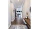 Inviting hallway with dark wood floors, neutral walls, and a view into the living room at 13820 Woodside Hollow Dr, Carmel, IN 46032