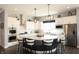Open kitchen layout featuring custom cabinetry, granite counters, and a center island with seating at 13820 Woodside Hollow Dr, Carmel, IN 46032